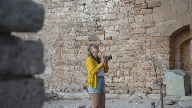 Female tourist takes photographs on excursion.