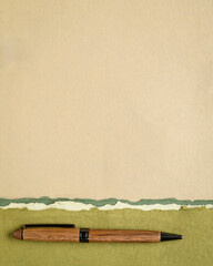 abstract paper landscape in pastel earth tones tones - collection of handmade rag papers with a wooden pen