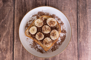 
Sweet sandwich with banana and chocolate cream on plate