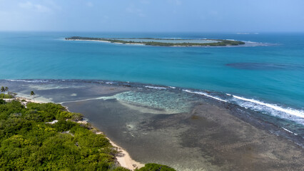 Aerial view of a key surrounded by a coral reef