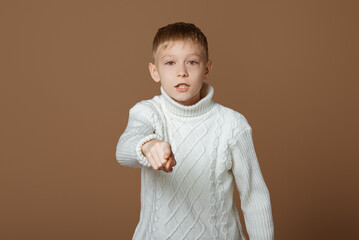 Hey you! Portrait of emotional teen boy pointing finger to camera, looking with suspicion and...
