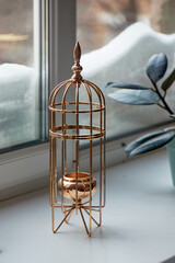 Gold metal candle holder in the shape of a bird cage. Interior detail - 743937586