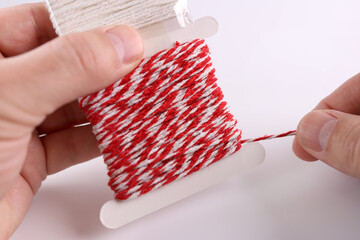 A skein of woolen white and red cord. Rope for household needs.