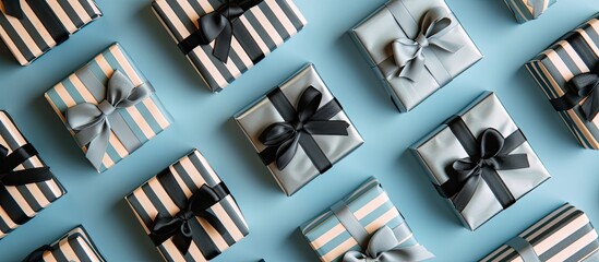 A top view image showcasing numerous striped gift boxes with grey ribbon arranged on a vibrant blue surface.