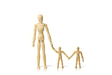 Concept image of a wooden mannequin adult with two children holding hands isolated on a white background with copy space.