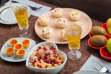 Champagne sparkling in glasses on the table, salad and appetizers buffet