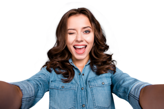 Self-portrait of nice cute coquettish cheerful lovely attractive dreamy brunette caucasian girl with wavy hair in casual denim shirt, winking, isolated over grey background