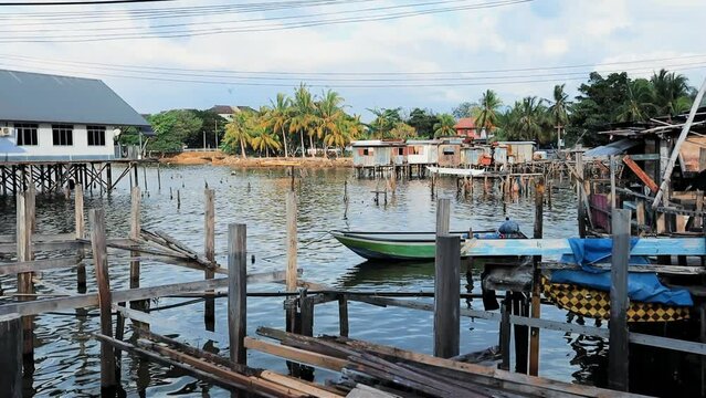 Fishing village houses over the water garbage poor areas in Sabah province in Malaysia