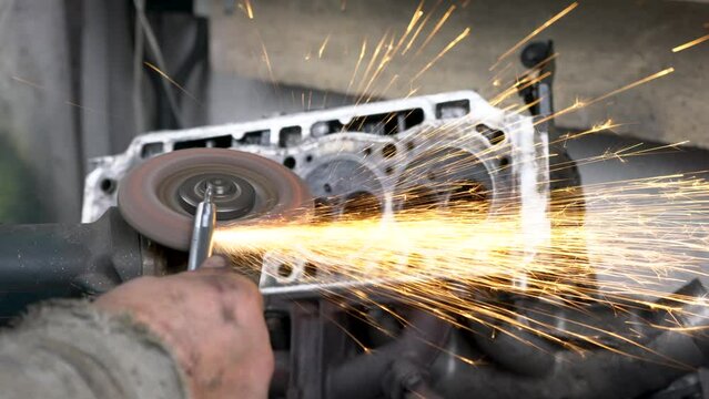 A mechanic assembles an internal combustion engine.