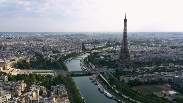PARIS, FRANCE - MAY 30, 2023: Aerial view of Tour Eiffel Tower and Seine River bridge and historical city center. Famous touristic landmark, world heritage of architectural masterpieces