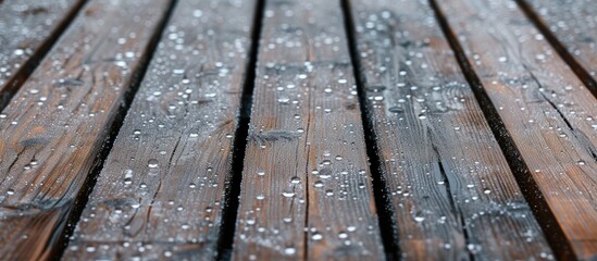 A wooden balcony that is wet with small hailstones. with copy space image. Place for adding text or design