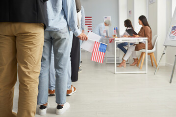 Cropped photo of a group of unrecognizable american citizens people standing in polling station....