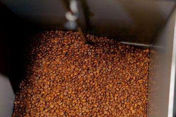 Obraz premium close-up of a coffee roasting factory inside drum roasting stirring coffee