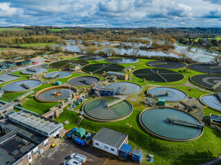 Medium telephoto aerial shot of sewerage treatment plant near Salisbury, UK