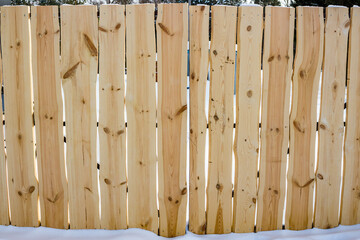 View of a wooden gate made from fresh slabs