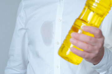 An unrecognizable man showing a greasy stain on his shirt