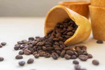 Edible cookie coffee cup filled with coffee bean, eco friendly alternative for takeaway cup.
