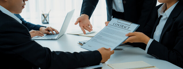 Two business executive in boardroom discuss term and company merging agreement, review corporate...
