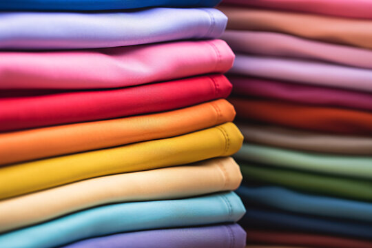 Stacks of neatly folded colorful clothes