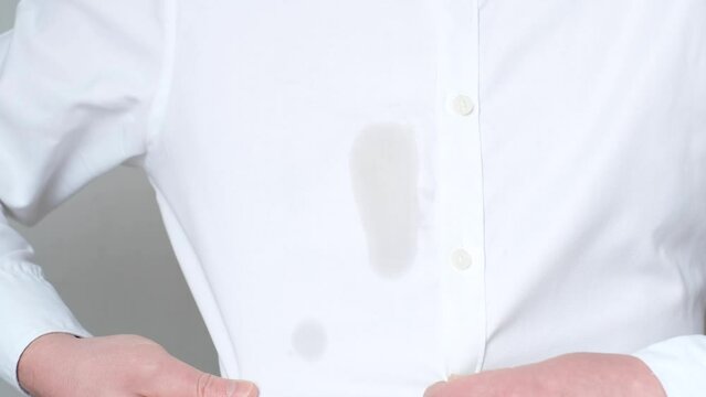 An unrecognizable man showing a greasy stain on his shirt. Spoiled clothes. daily life stain concept. 4k, video