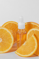 Citrus essential oil, vitamin c serum with fresh juicy orange fruit on white background. Organic Spa Cosmetic With Herbal Ingredients. Toning. High dose vitamin c synthetic for skin