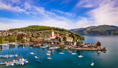 Canton Bern in Switzerland. aerial drone panorama of lake Thun and the Spiez village with medieval...