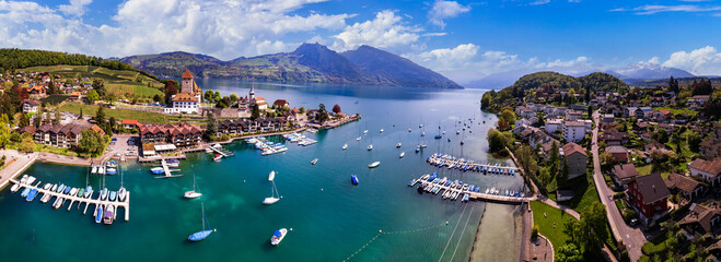 Switzerland. aerial drone panorama of lake Thun and the Spiez village with medieval castle and old town. cantone Bern - 744028947