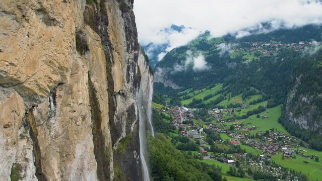 Switzerland cliffside and waterfalls and view of town