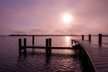Fototapeta na wymiar Big sun rising over a lavender morning on the St. Johns River