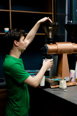 A coffee tester at coffee factory is preparing to test freshly ground coffee from the roasting plant