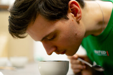 close up at coffee roasting factory in the kitchen bowl of coffee stirring sniffing coffee