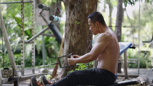 Thai man doing the back rowing exercise