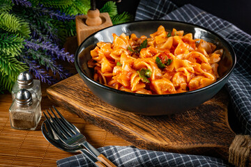 Pieces of chicken with noodle in tomato and herb sauce.