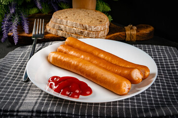 Frankfurter sausages with ketchup.