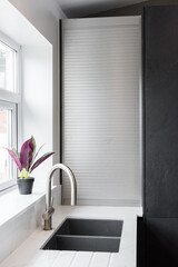 Beautiful grey slate and marble European style sink modern home kitchen. Elegant minimal home interior style decor. Luxury living standards at home.