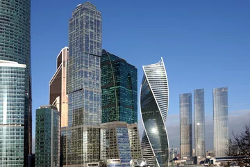 Foto op Plexiglas Moscow City International Business Centre dense standing high skyscraper buildings against cloudless blue sky © DyMaxFoto