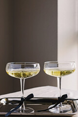 Elegant drinks, sparkling wine in glasses decorated with bows