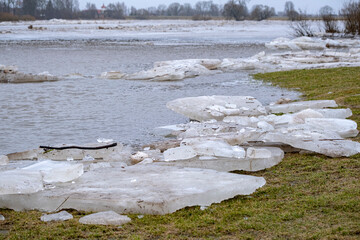 blocks of ice near the river bank. Ice drift of ice floes on rivers and lakes under the influence...