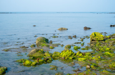 Landscape scene of a sea beach having rocks