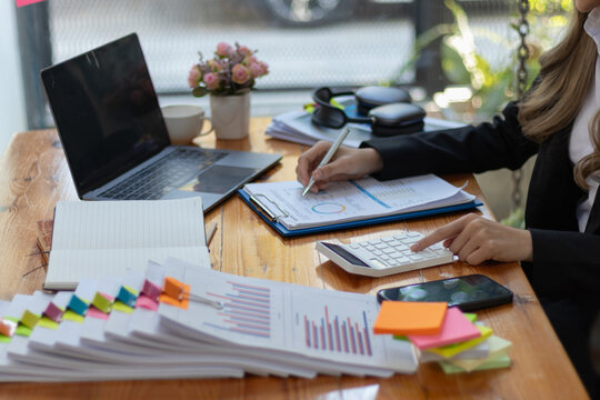 The pile of documents on the secretary's desk was prepared for the executives who would be attending the meeting. Several documents were stacked on the secretary's desk ready for the attendees.