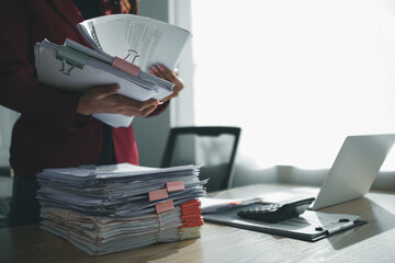 The pile of documents on the secretary's desk was prepared for the executives who would be...