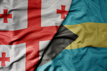 big waving national colorful flag of bahamas and national flag of georgia .