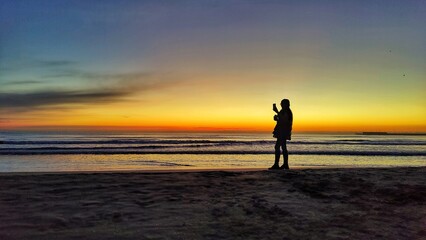 Fototapeta na wymiar receiving the sunrise on Cabanyal beach
