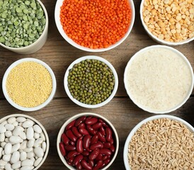 Different grains and cereals on wooden table, flat lay