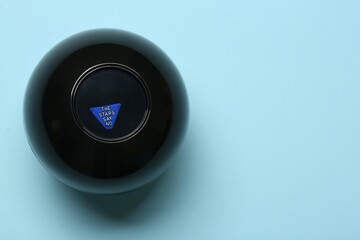 Magic eight ball with prediction The Stars Say No on light blue background, top view. Space for text