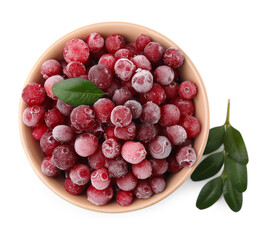Frozen red cranberries in bowl and green leaves isolated on white, top view