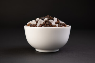 bowl of crystal sugar on black background