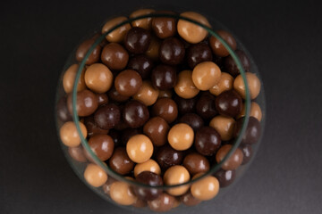top view of chocolate balls in a transparent glass vessel
