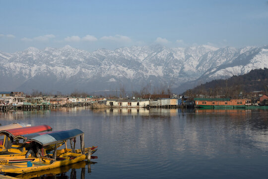 Srinagar, Jammu and Kashmir /  India - December 17, 2019 : A view of the Dal lake, and the beautiful mountain range in the background in the city of Srinagar.