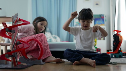 Siblings Enjoying Playtime with Toy Parking Lot in Bedroom, Brother and Sister Sharing Fun Moment